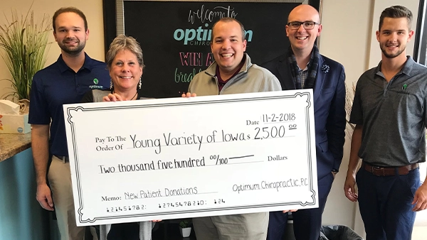 Chiropractor West Des Moines IA Brett Vowles And Derek Reicks With Team And Happy Patient Chiropractor West Des Moines IA Brett Vowles And Derek Reicks With Team And Happy Patient
