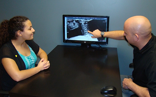 Chiropractor West Des Moines IA Brett Vowles Pointing To XRay Chiropractor West Des Moines IA Brett Vowles Pointing To XRay